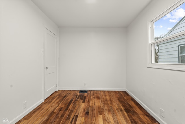 spare room featuring dark hardwood / wood-style flooring