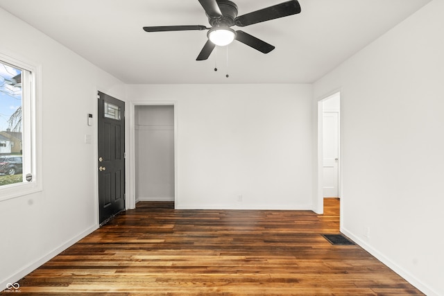 unfurnished room with ceiling fan and dark hardwood / wood-style flooring