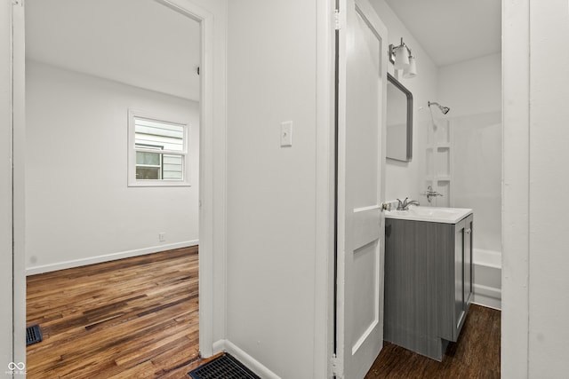 bathroom featuring vanity, hardwood / wood-style floors, and a shower