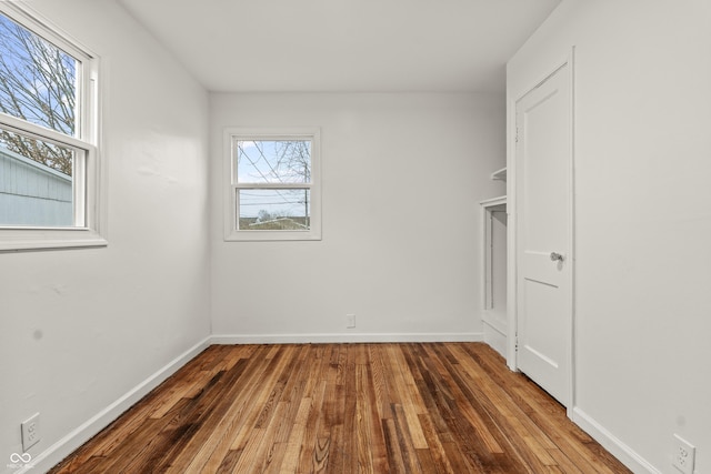 spare room featuring wood-type flooring