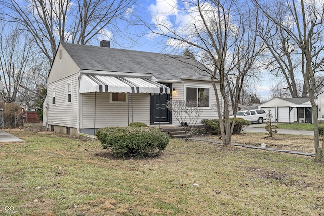 bungalow-style house with a garage and a front lawn