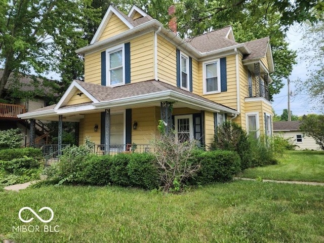 view of front of property with a porch and a front yard