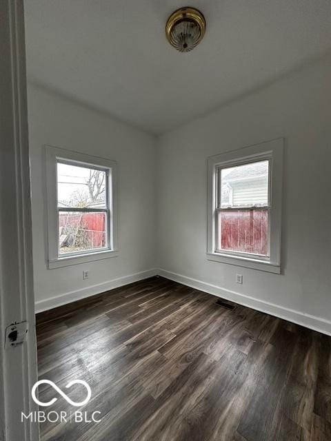 unfurnished room with dark hardwood / wood-style floors