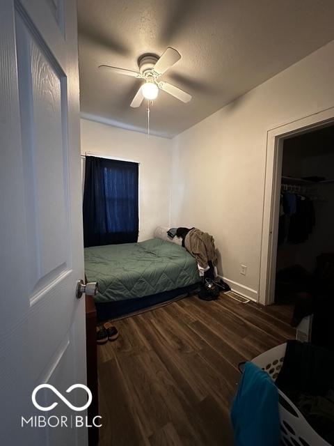 bedroom with ceiling fan and hardwood / wood-style floors