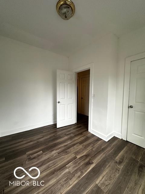 empty room with dark wood-type flooring