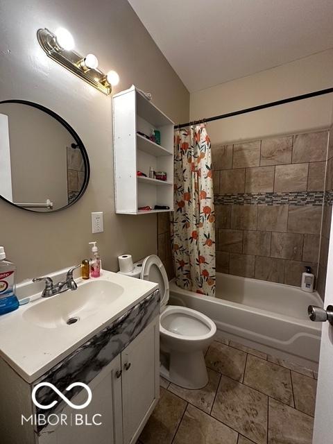 full bathroom with vanity, shower / tub combo, tile patterned floors, and toilet