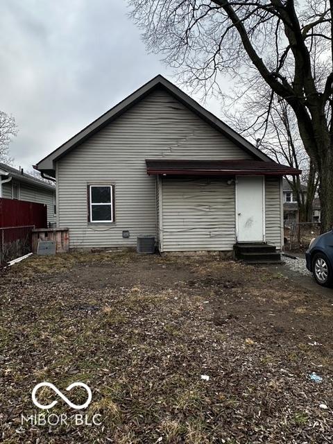 rear view of house featuring central AC unit