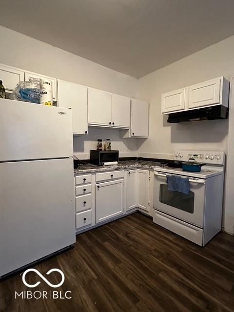 kitchen with dark hardwood / wood-style floors, white cabinets, and white appliances