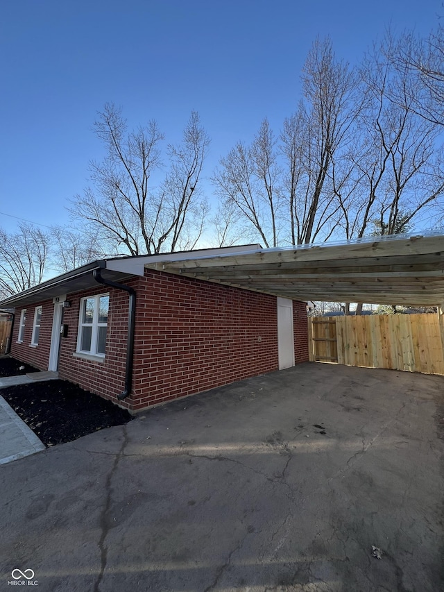 view of side of home with a carport