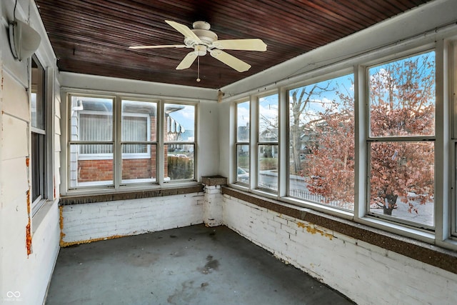 unfurnished sunroom with ceiling fan and wooden ceiling