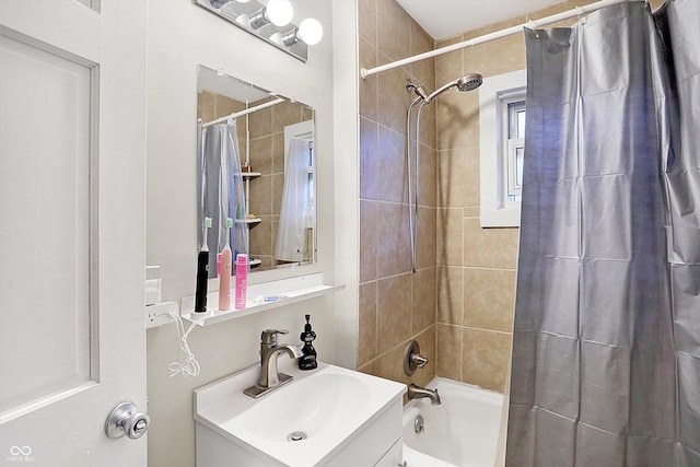 bathroom featuring shower / bathtub combination with curtain and vanity