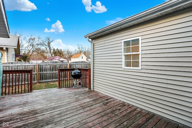 wooden deck featuring a grill