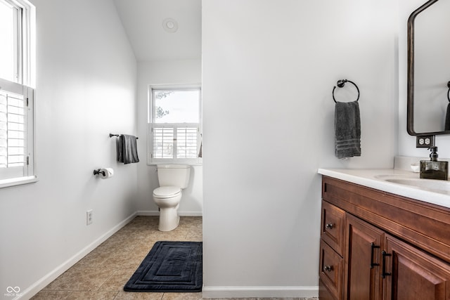 bathroom featuring vanity, tile patterned floors, and toilet