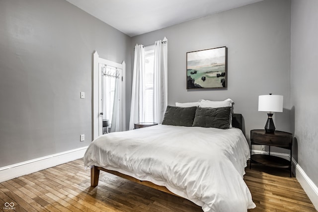 bedroom with hardwood / wood-style floors