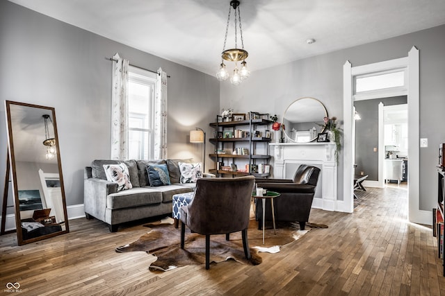 living room featuring hardwood / wood-style flooring and a notable chandelier