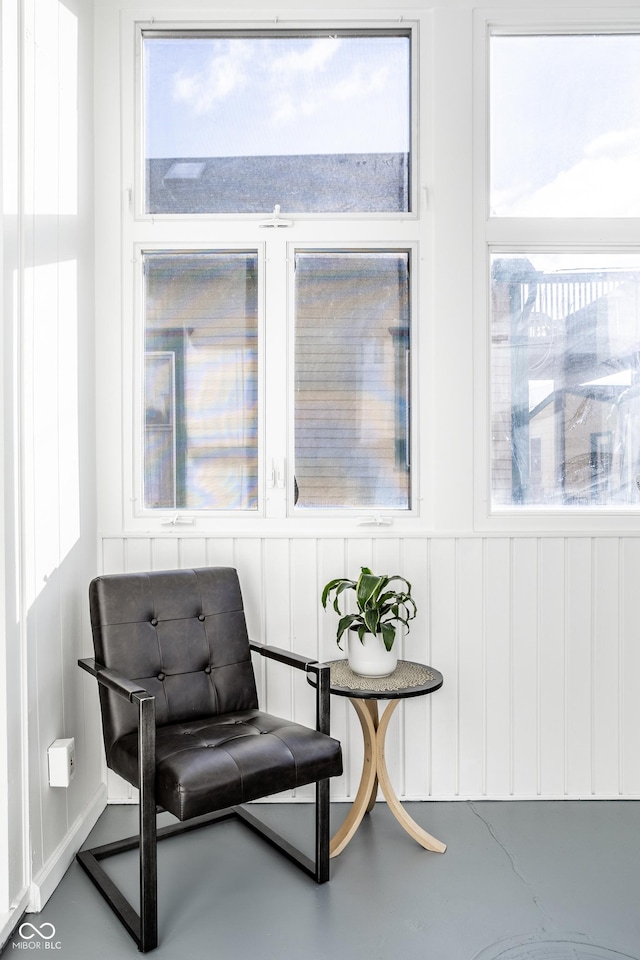 sitting room with concrete flooring and a healthy amount of sunlight