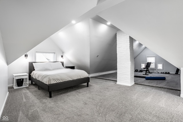 bedroom with ornate columns, carpet, and lofted ceiling