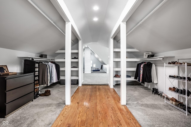 spacious closet featuring lofted ceiling and carpet floors