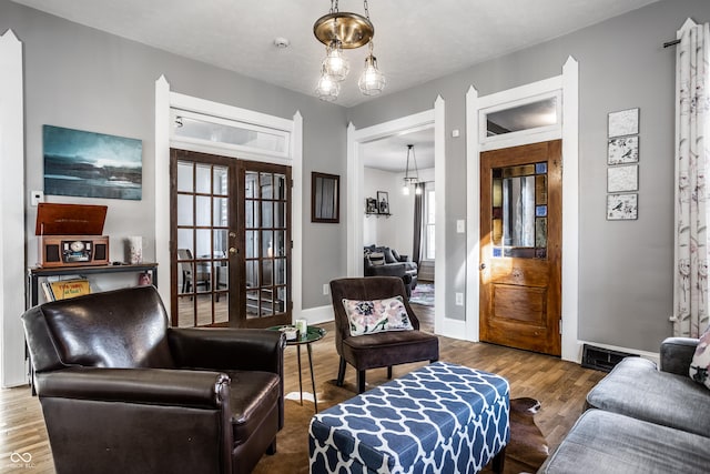 living room with french doors and wood-type flooring