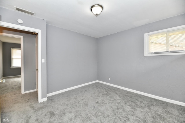 unfurnished room featuring light colored carpet