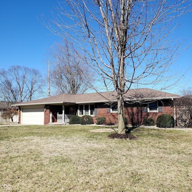 single story home with an attached garage, brick siding, and a front yard