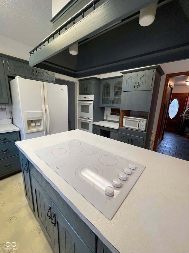 kitchen featuring white appliances and gray cabinetry