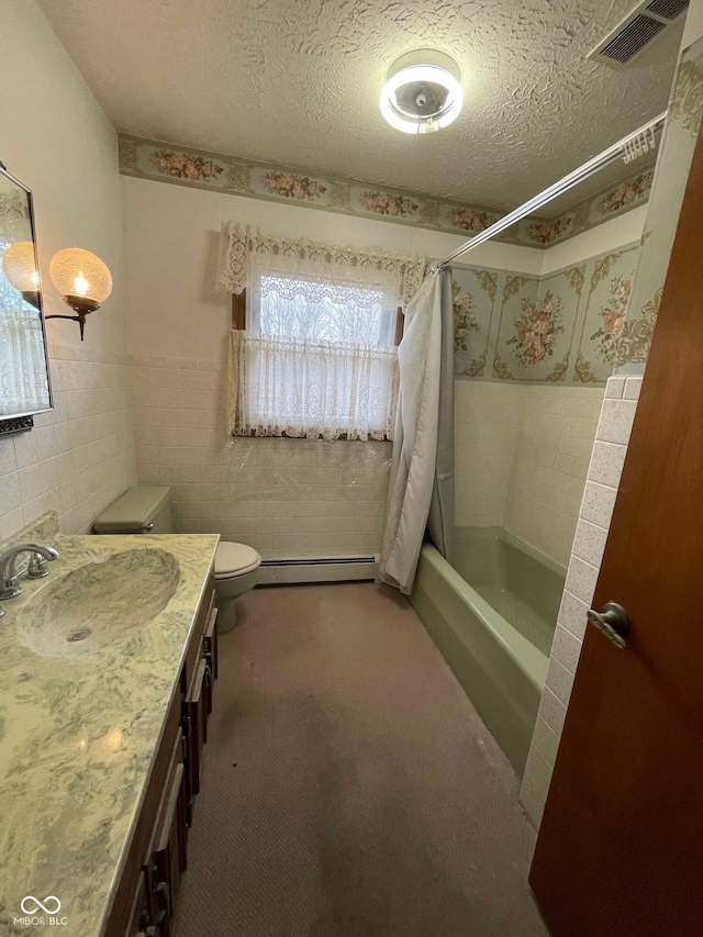 full bathroom featuring tile walls, vanity, baseboard heating, toilet, and a textured ceiling