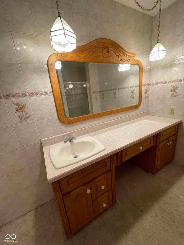 bathroom with tile walls, vanity, and an enclosed shower