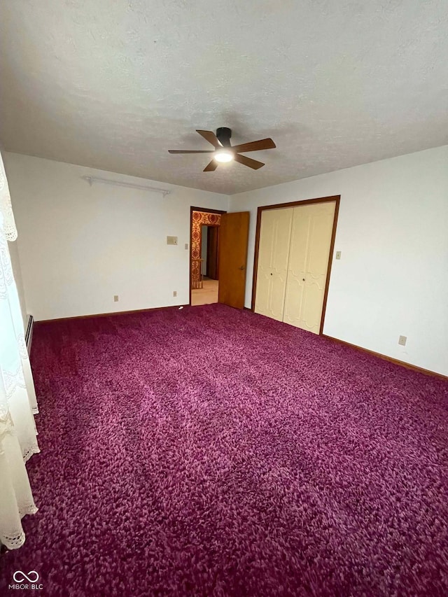 unfurnished bedroom featuring ceiling fan, carpet floors, and a textured ceiling