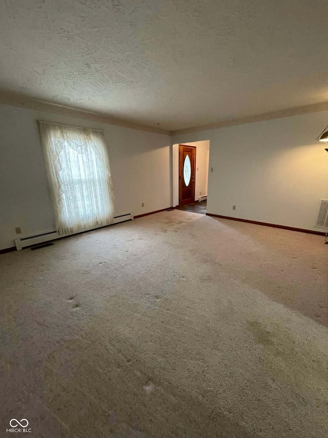 unfurnished living room featuring a textured ceiling, carpet, and a baseboard heating unit