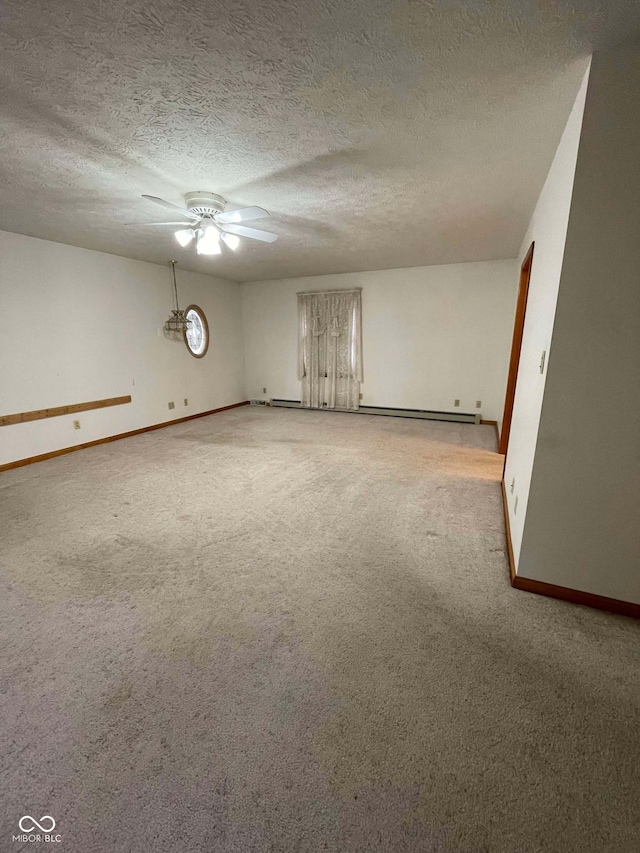 carpeted empty room with ceiling fan and a textured ceiling