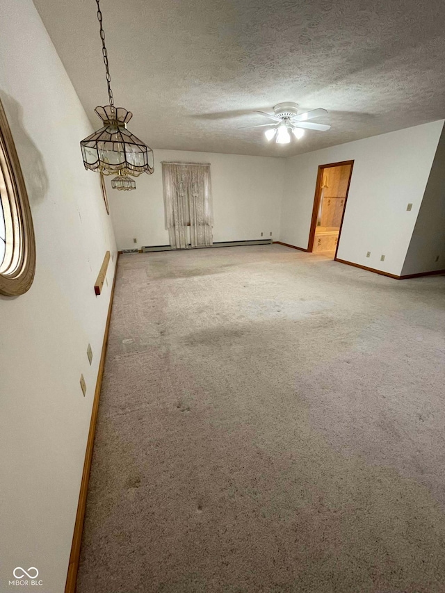 carpeted empty room featuring ceiling fan and a textured ceiling