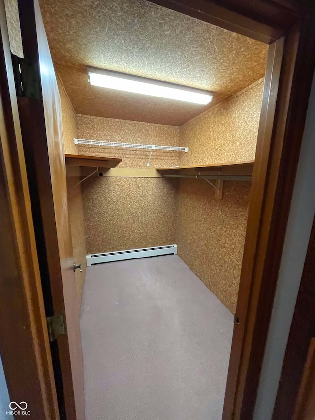 spacious closet with a baseboard radiator