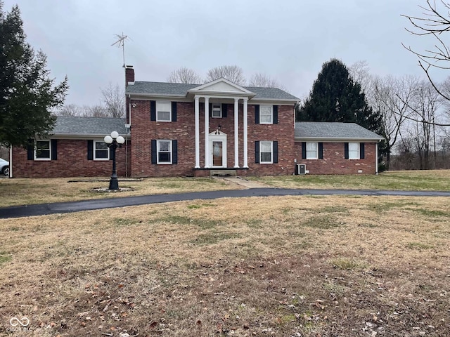 greek revival inspired property with a front yard