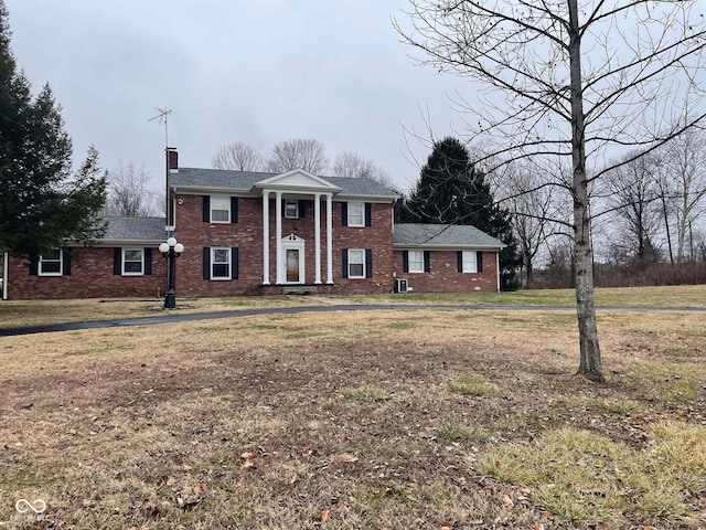 greek revival inspired property with a front lawn