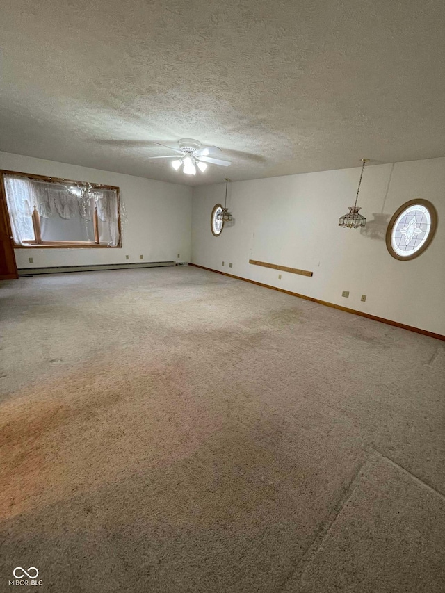 carpeted empty room with baseboard heating, ceiling fan, and a textured ceiling