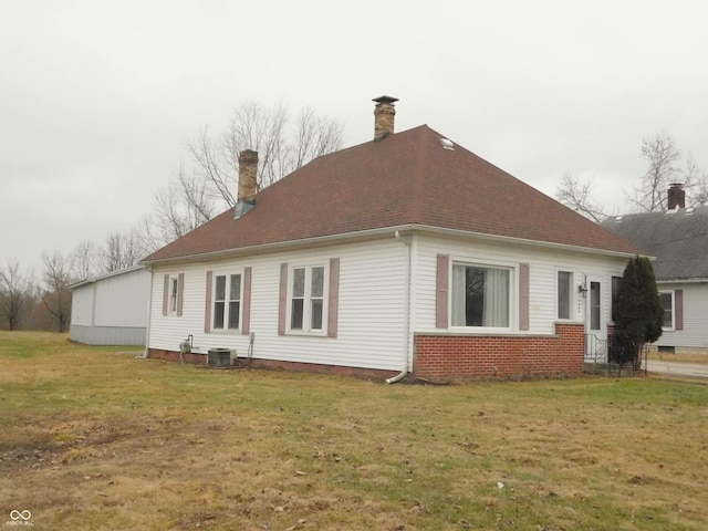 view of property exterior with cooling unit and a lawn