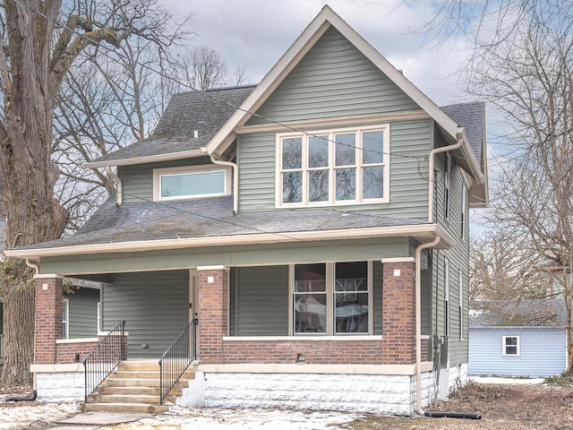 view of front of home featuring a shed and covered porch