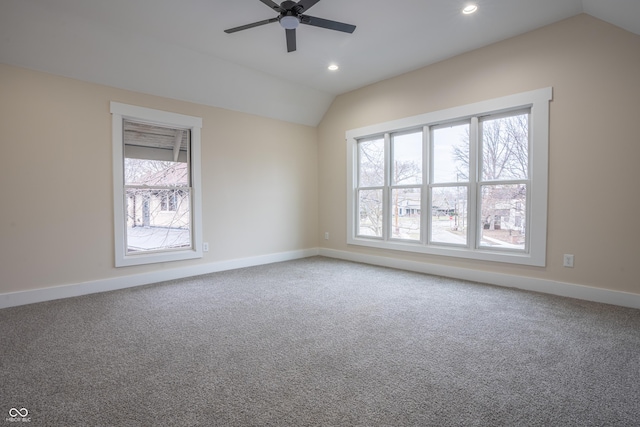 spare room featuring lofted ceiling, carpet, and ceiling fan