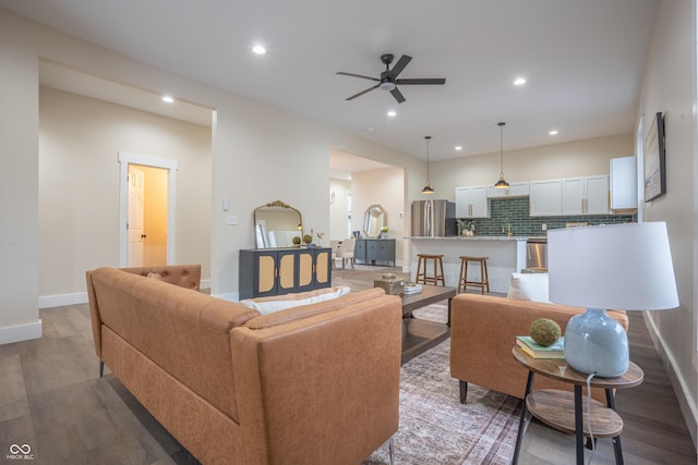 living room with sink, hardwood / wood-style floors, and ceiling fan