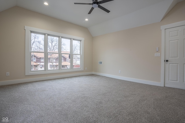 carpeted empty room featuring lofted ceiling and ceiling fan