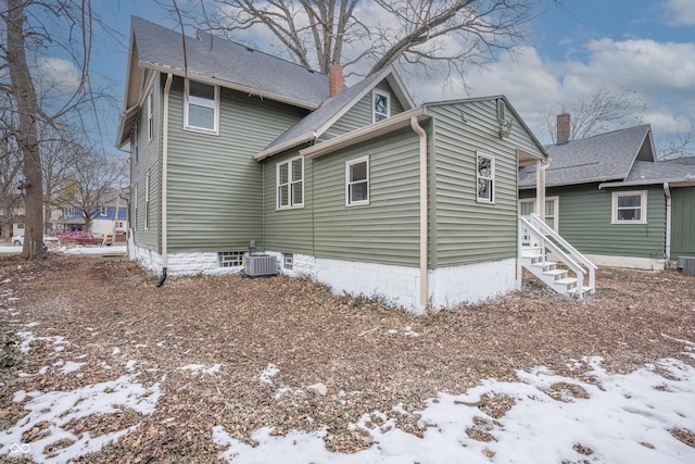 snow covered property featuring cooling unit