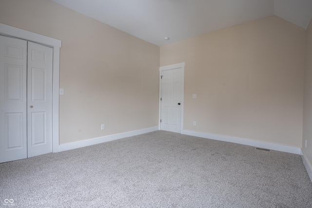 interior space with lofted ceiling and carpet floors