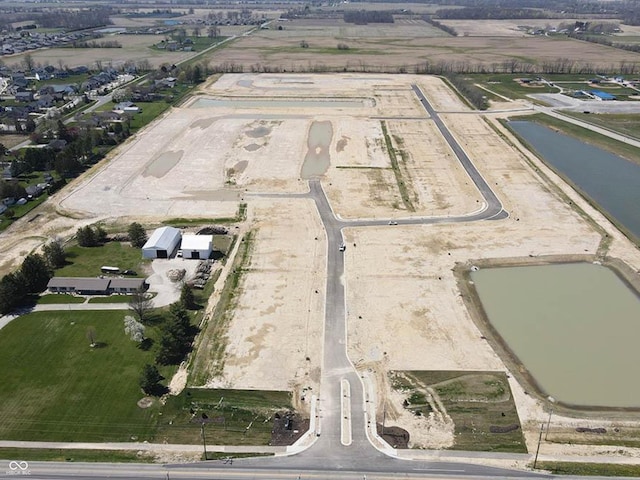 birds eye view of property with a rural view and a water view