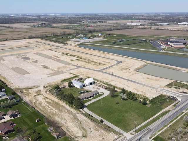 drone / aerial view featuring a water view and a rural view