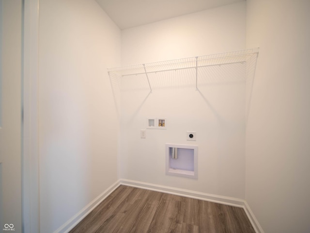 washroom featuring dark wood-type flooring, washer hookup, laundry area, and hookup for an electric dryer