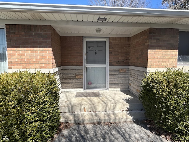 property entrance with brick siding