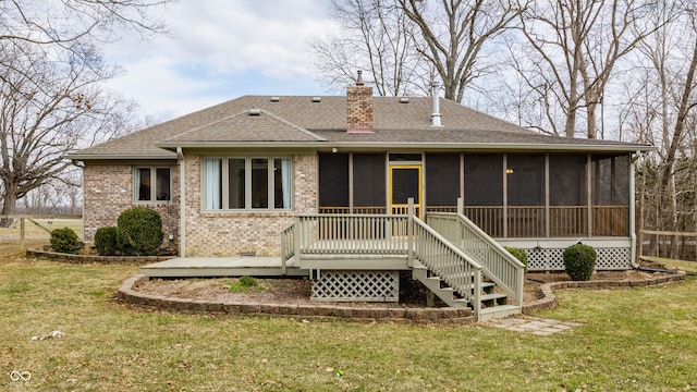 back of property featuring a lawn, brick siding, roof with shingles, and a chimney