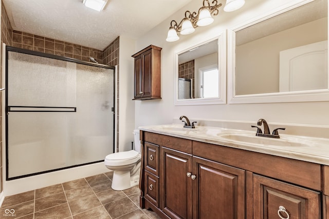 bathroom with a sink, toilet, and a shower stall