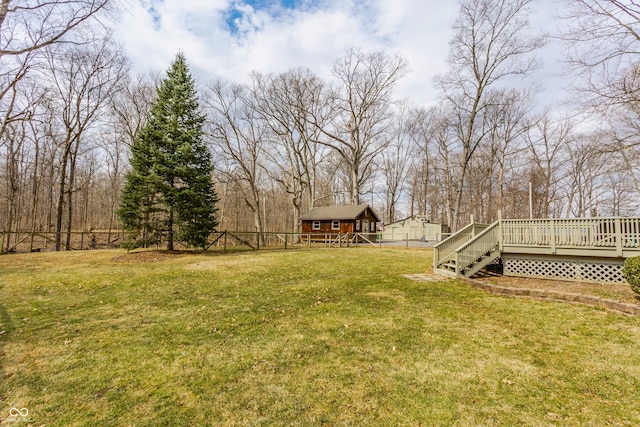 view of yard featuring a wooden deck and fence